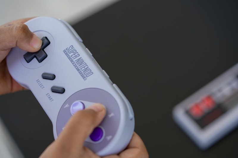 Super Nintendo Entertainment System console with controller on a surface