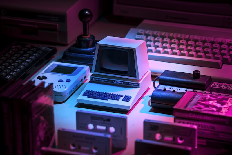 Vintage gray game console and joystick on a surface — classic retro gaming hardware